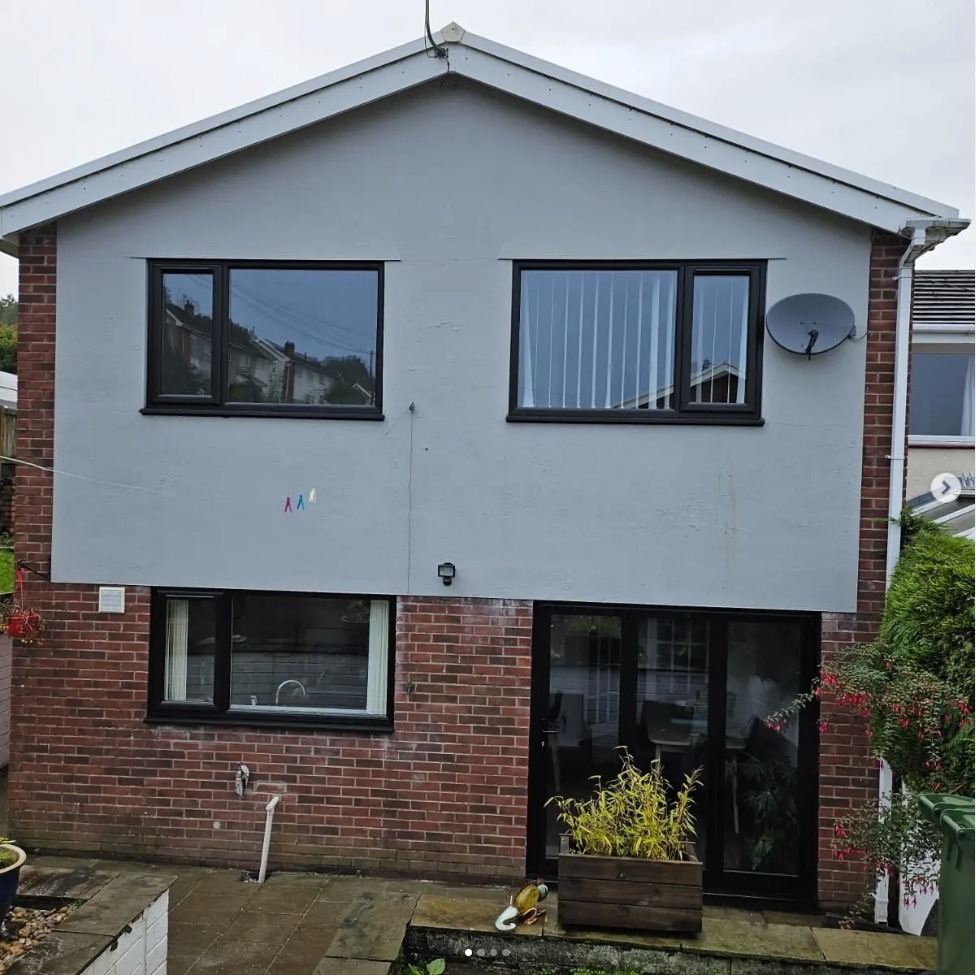 Home fitted with black aluminium bifold doors and windows in South Wales